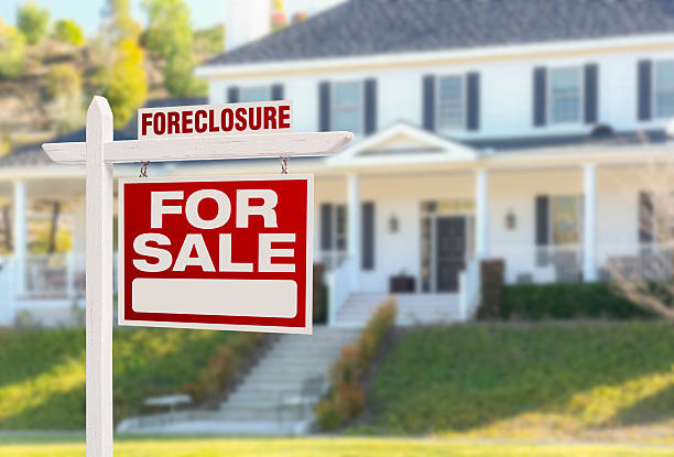 Foreclosure Home For Sale Sign in Front of Large House Foreclosure Home For Sale Real Estate Sign in Front of Beautiful Majestic House. foreclosure stock pictures, royalty-free photos & images