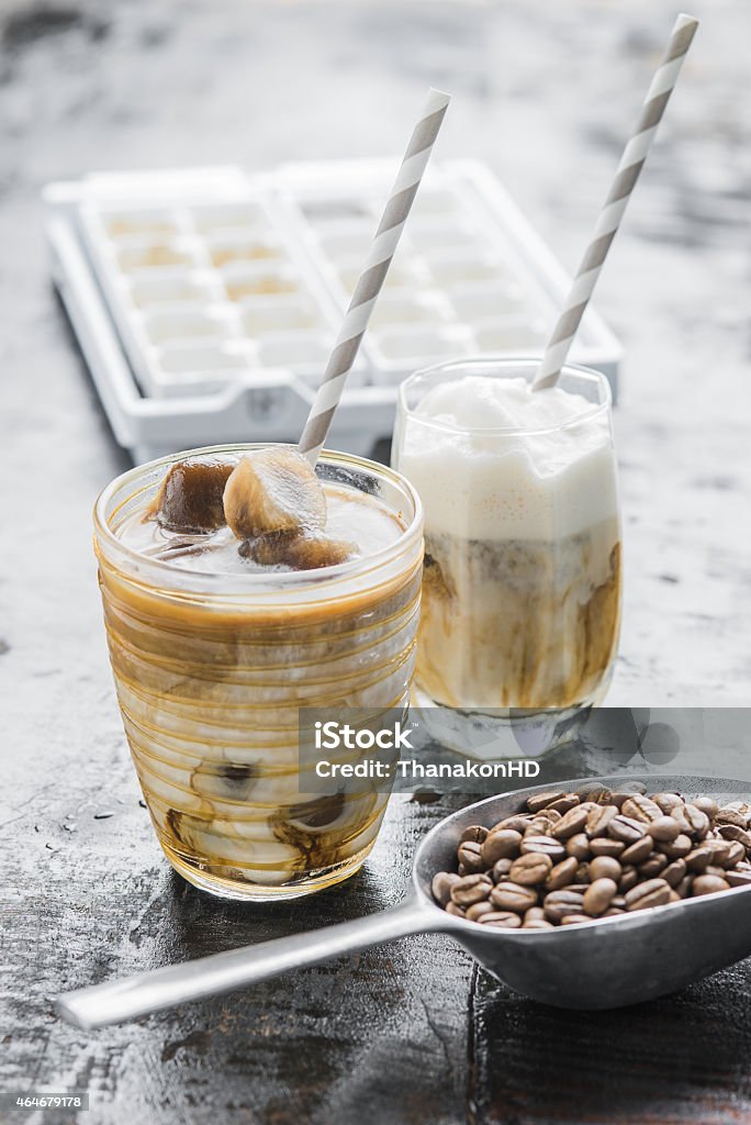 Arabica Iced Cafe Latte Iced coffee latte homemade making from ice cubes coffee frozen served with milk. Drinking Glass Stock Photo
