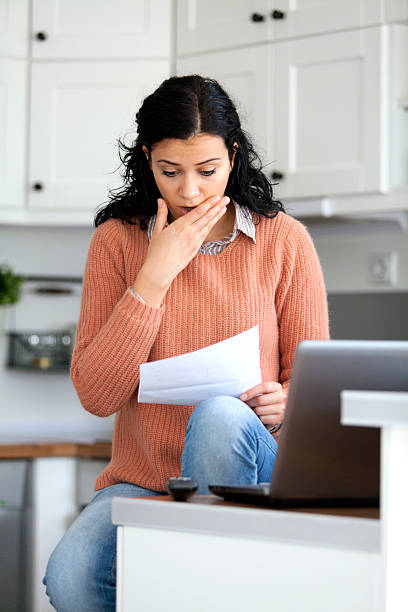 istock young woman looking the bills 464681720