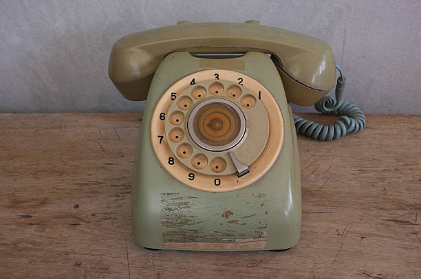 istock Old phone on wood background and concrete wall. 464681774
