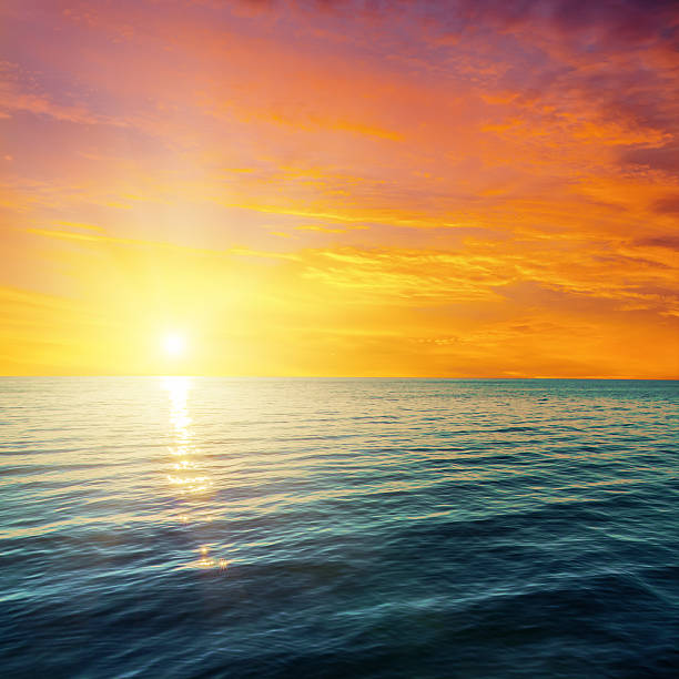 istock Red and orange sunset over dark sea 464682328