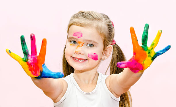 istock Cute smiling little girl with hands in paint 464683393