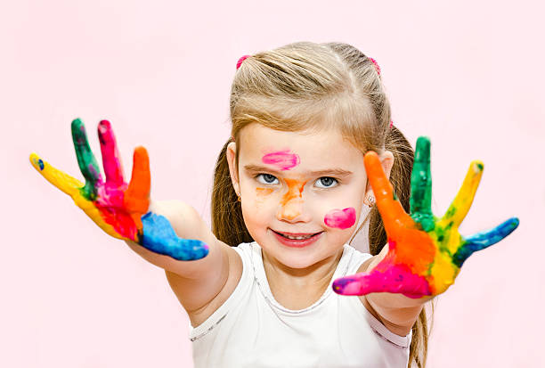 istock Cute smiling little girl with hands in paint 464684847