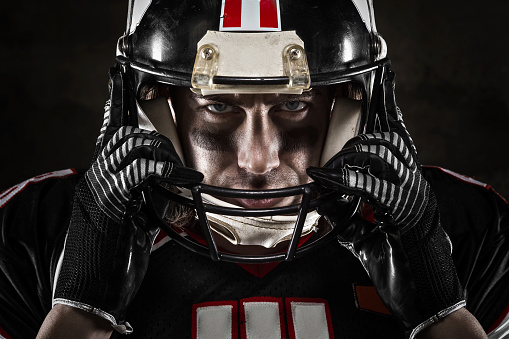 Portrait of american football player looking at camera with intense gaze