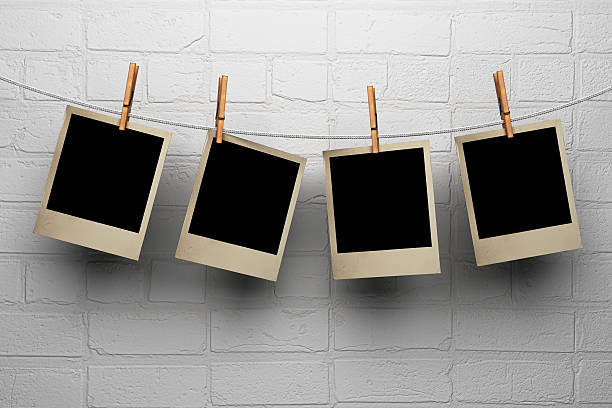 istock Photos hanging on clothespegs against a wall 464689677