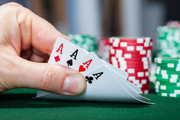 istock Poker player holding playing cards 464690357