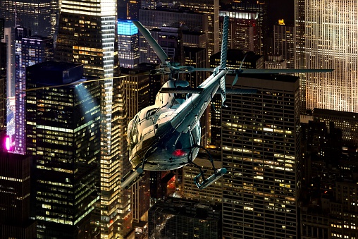Helicopter night flight between the skyscrapers of New York Manhattan district