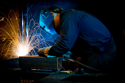 A welder fabricating structural steel