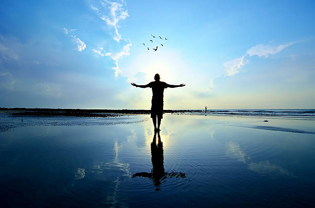 istock Silhouette of Man Raising His Hands 464696850