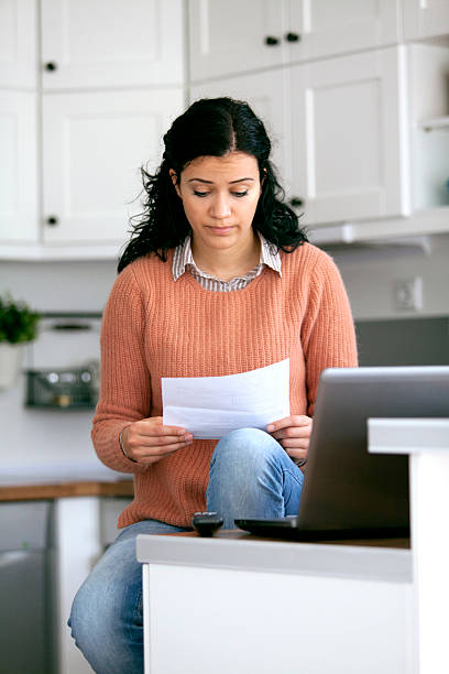 istock young woman looking the bills 464697580