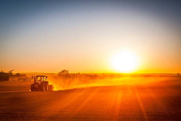 Farmer preparing his field in a tractor ready for spring stock photo