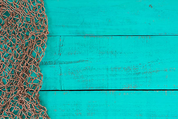 Blank antique teal blue wooden sign with fish net border