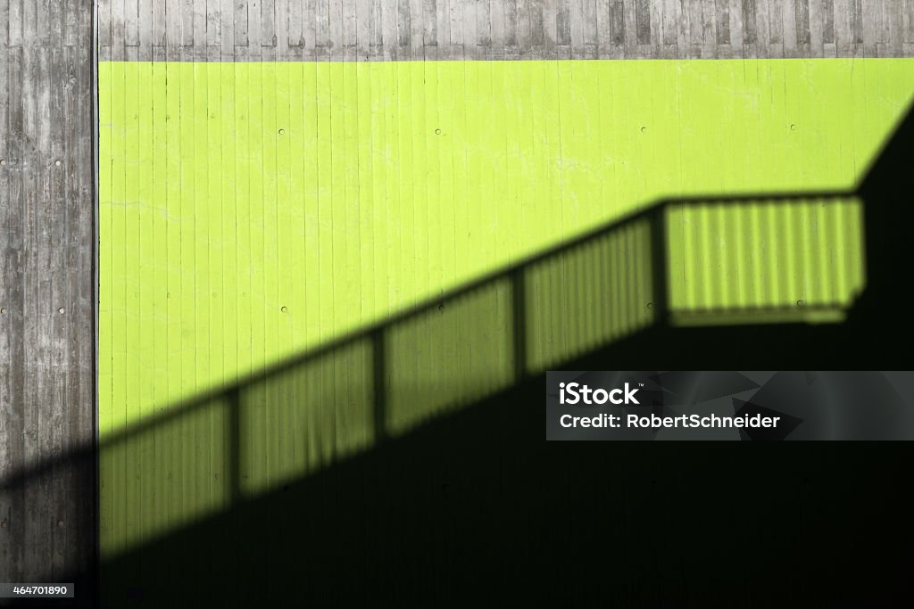 Shadow of a banister in a city Shadow of a banister on a green wall of exposed concrete in a city  2015 Stock Photo