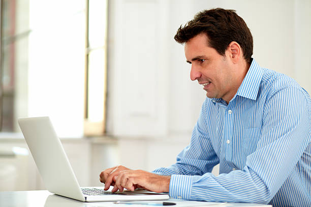 istock Adult latin enterpreneur using his laptop 464702847