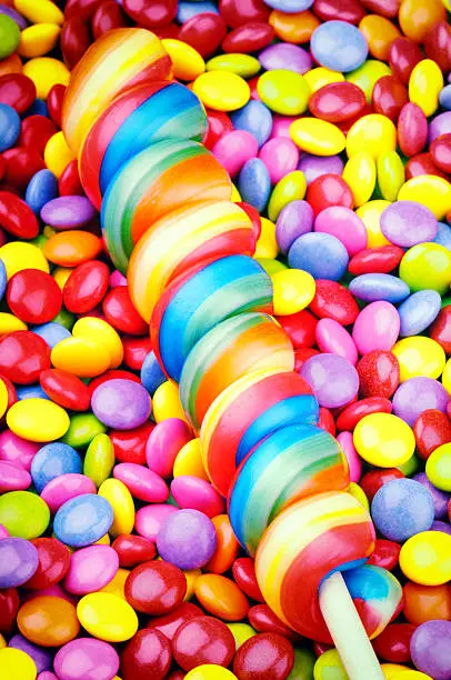 Striped lollipop and multicolored smarties