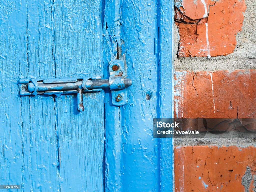 Espagnolette on old blue painted door of shed Espagnolette on old blue painted door of shed close up 2015 Stock Photo