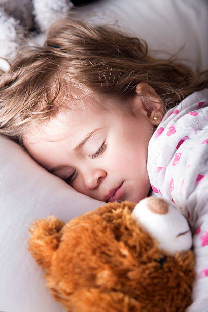 istock Sweet child sleeping with teddy bear 464721840