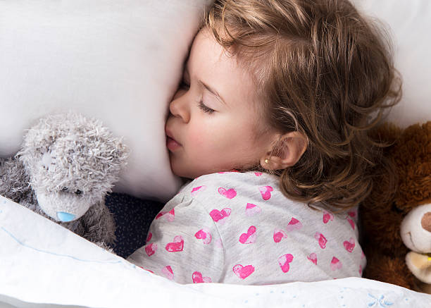 istock Sleeping child with toys 464721846