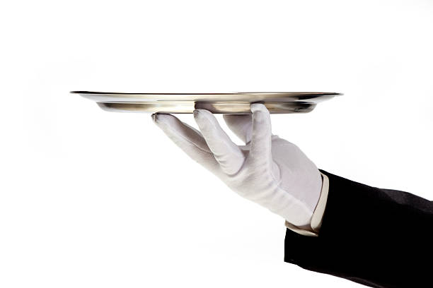 istock hand in white glove holding empty serving tray 464724920