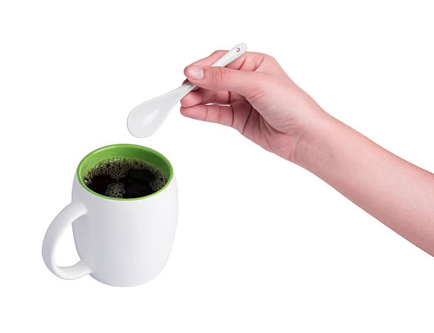 istock Hand holding white spoon and red cup of coffee 464725292