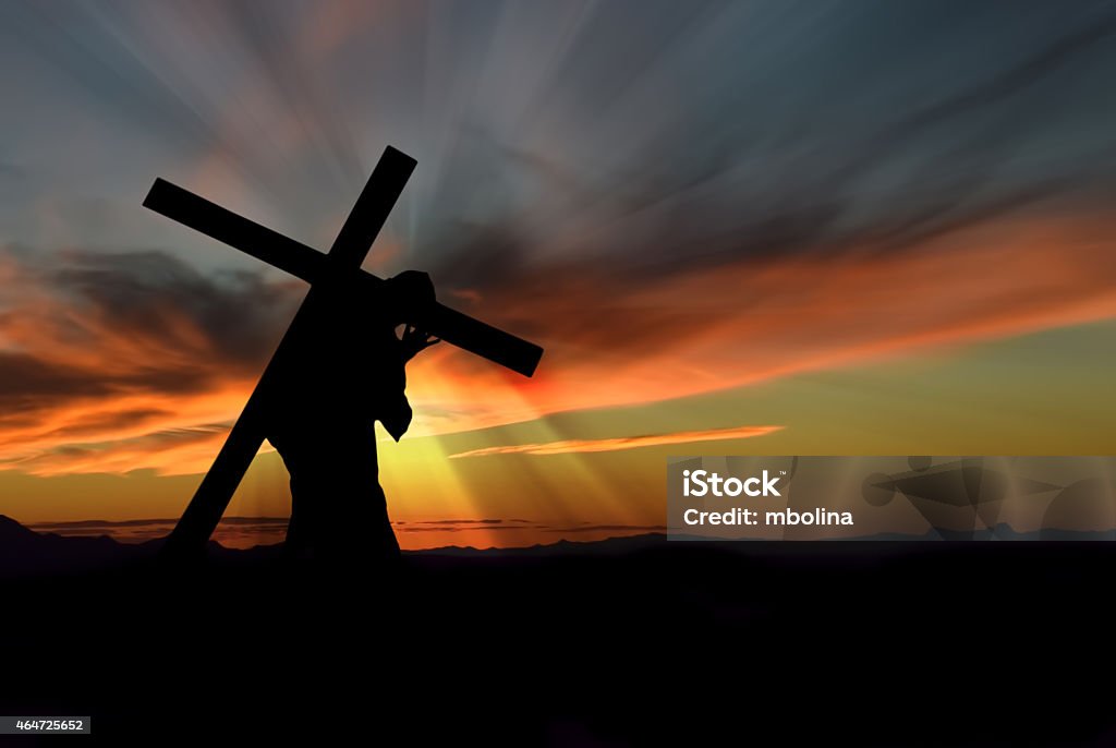 Jesus Christ Carrying Cross Christ carrying cross up Calvary on Good Friday over dark and stormy sky Religious Cross Stock Photo