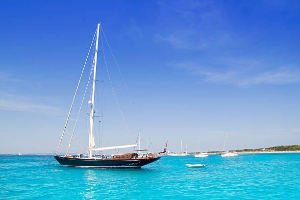 istock anchored sailboats in turquoise Formentera beach 464726018
