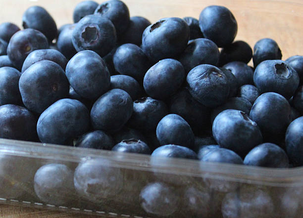 istock Image of fresh organic blueberries in plastic punnet, healthy breakfast 464732002