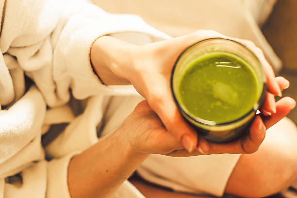 istock Toned Ariel green smoothies on white spa robe 464735872