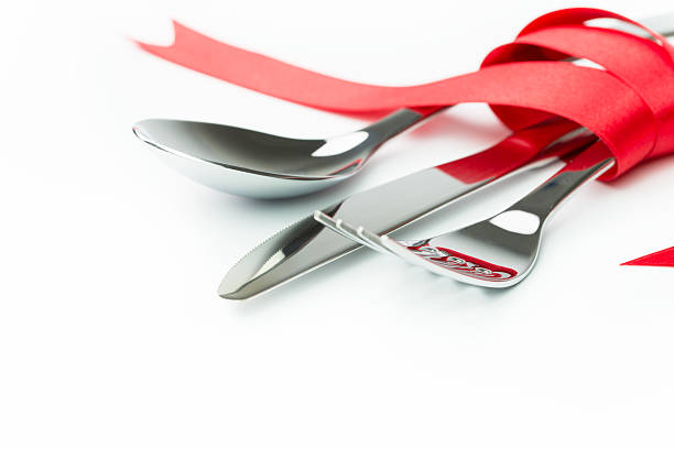 istock Fork, spoon and knife tied up with red ribbon 464737687
