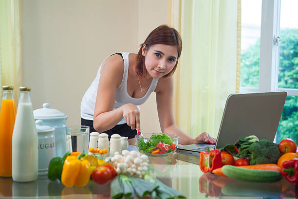 istock Young asian woman looking for a recipe 464739408