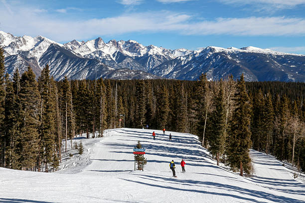 istock Ski run with many people skiing and rugged mountains 464740334