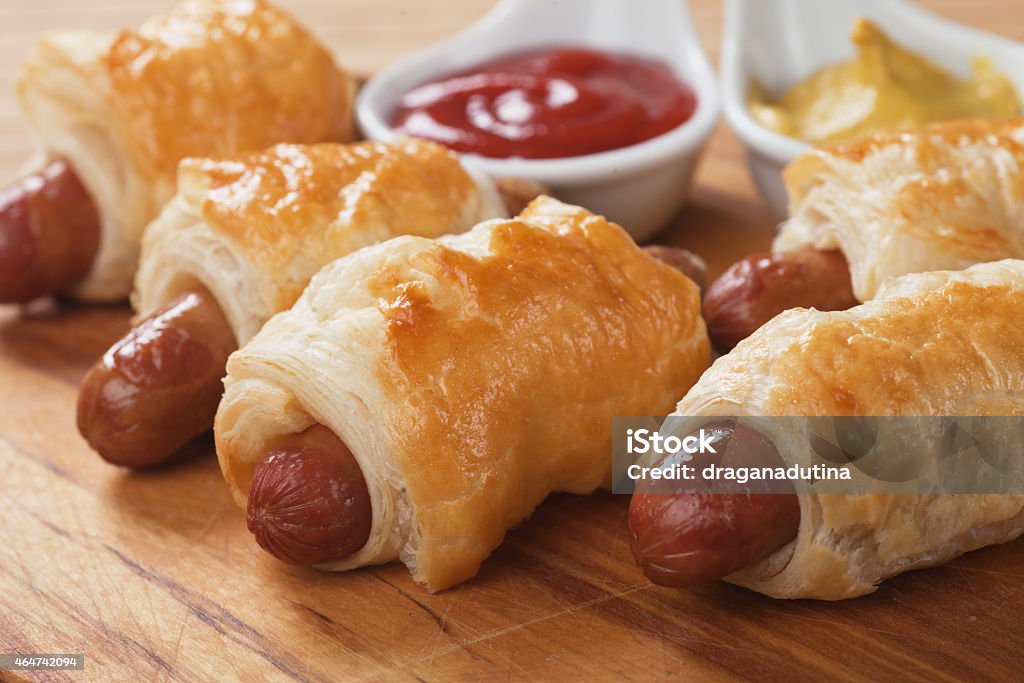 Sausage rolls Pigs in blanket, sausage rolls with ketchup and mustard 2015 Stock Photo