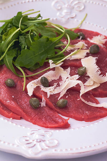 istock Beef carpaccio with parmesan and rocket salad 464746058