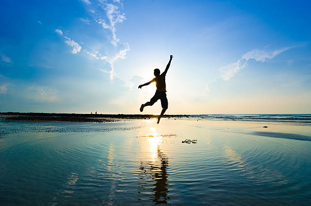 istock Silhouette of a man jumping over sun rising up 464753676