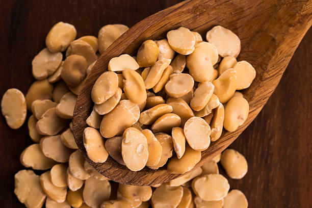 istock broad bean dry on wooden table 464754078