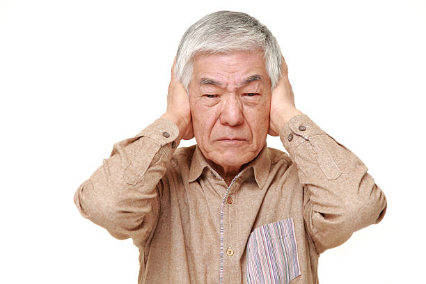istock senior Japanese man suffers from noise 464754704