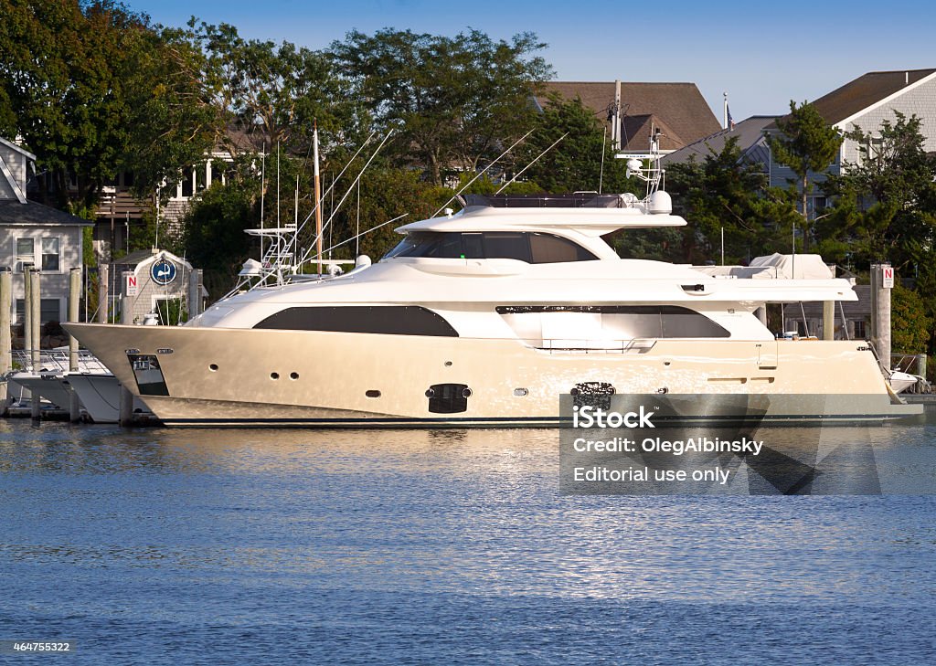 Yacht parked at Hyannis Marina, Cape Cod, Massachusetts, USA. Hyannis, MA, USA - September 14, 2014: Luxury Yacht parked at Hyannis Marina, Cape Cod, Massachusetts, USA. The image is lit by the evening sun. Canon EF 70-200mm f4L IS USM Lens. 2015 Stock Photo