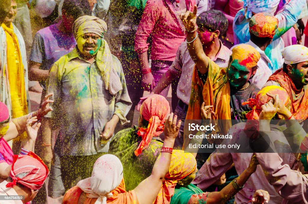 Holi Festival People, India Barsana, India - March 10, 2014: Group of male people covered with colour powder celebrating the Holi festival in Barsana village. Holi is the most celebrated and colorful religious festival in India, celebrated in spring by Hindus, Sikhs and others, people throwing coloured powder and coloured water at each other. 2015 Stock Photo