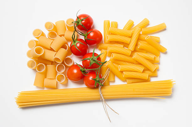 istock Various kind of pasta with tomatoes on white background 464756834