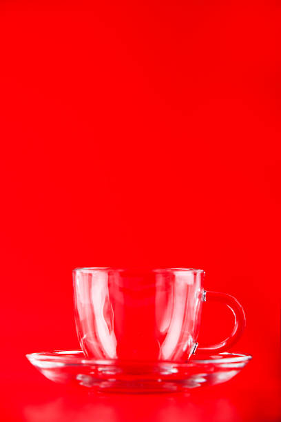 istock Glass cup in front of red background 464757080