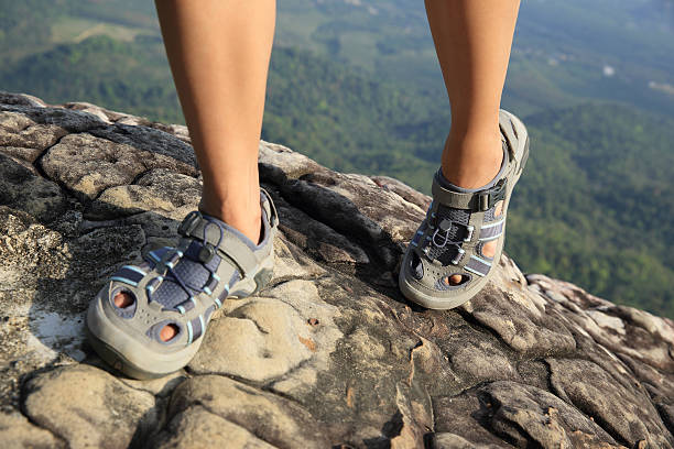 istock hiking woman legs climbing on mountain peak 464761858