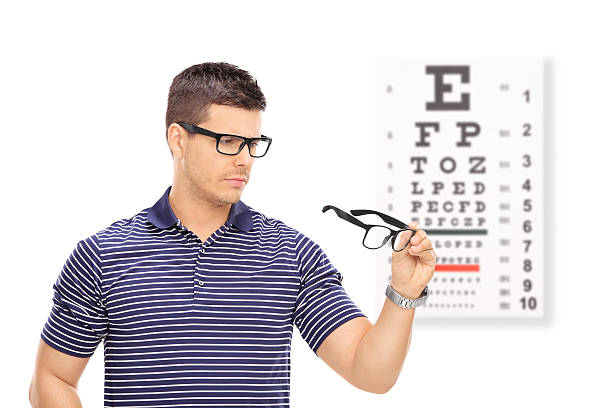 istock Man trying on glasses in front of an eye chart 464766250