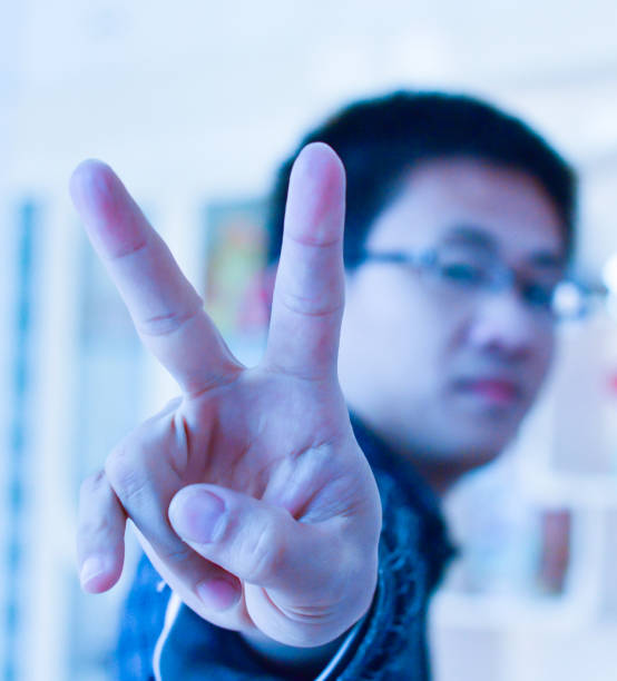 istock man with  fingers means victory 464766353