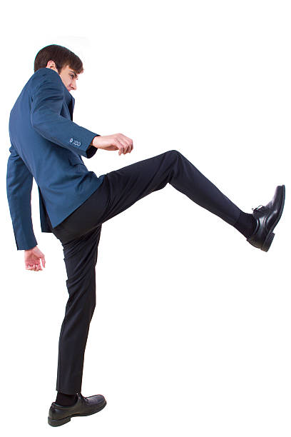 istock Young Businessman Kicking Something Imaginary 464768559