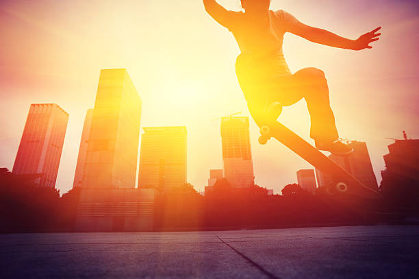 istock skateboarding woman jumping at  sunrise 464768886
