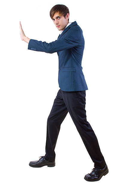 istock Businessman Pushing Against an Imaginary Obstacle 464769181