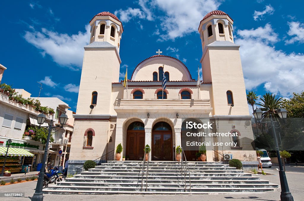 Orthodox Church Tessaron Martyron in Rethymno city on Crete, Greece. Crete, Retymno, Greece - July 23, 2014: Facade of the Orthodox Church Tessaron Martyron in Rethymno city, locals go along the street. 2015 Stock Photo