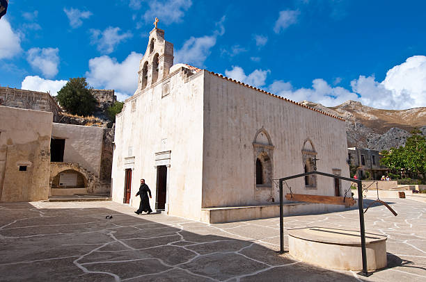 Crete, Greece - July 23, 2014: Preveli Monastery on the island, friar leaves the building. The Monastery of Preveli is aged since the end of the 17th century.