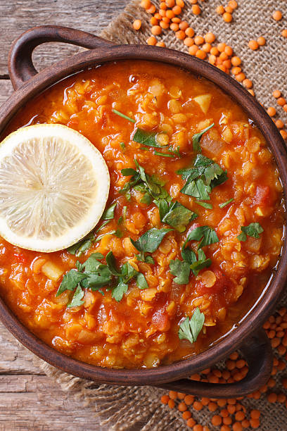 istock Red lentil soup with lemon and herbs vertical. top view 464773168