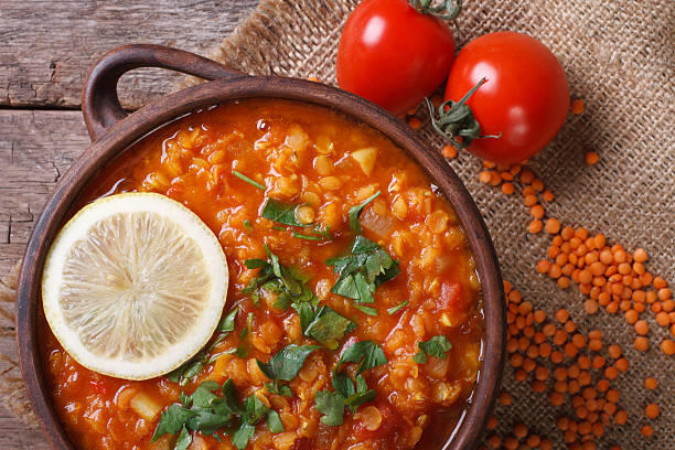istock Red lentil soup with tomatoes and lemon horizontal. top view 464776704